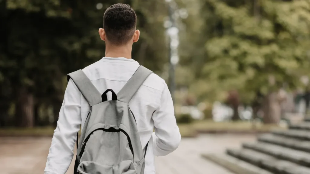A student going to university, shot from behind.