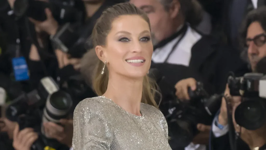 Gisele Bündchen wears a shimmery, long-sleeved silver gown at the 2017 Met Gala