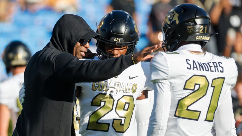 Head coach Deion Sanders with Rodrick Ward and Shilo Sanders at the NCCA college football game.
