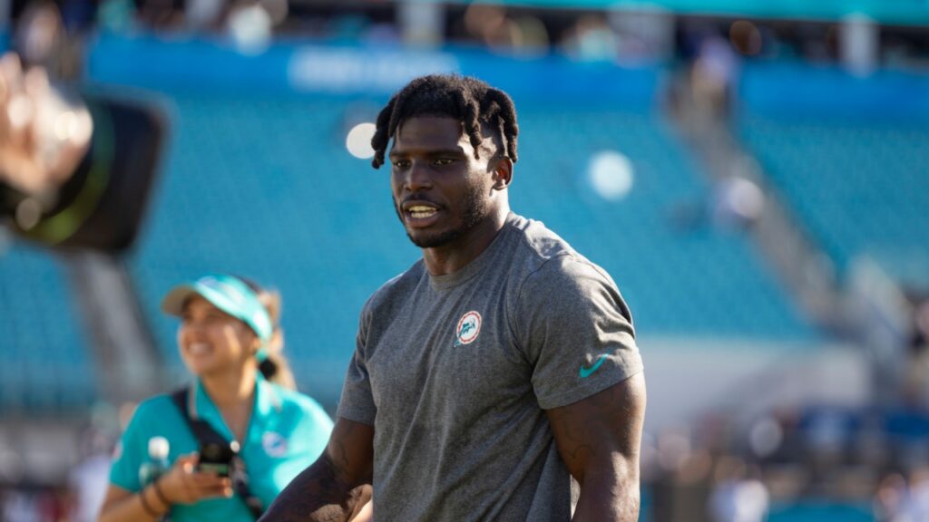 Tyreek Hill walking on the football field.