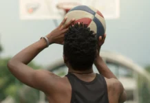 Back view of a basketball player aiming for the net