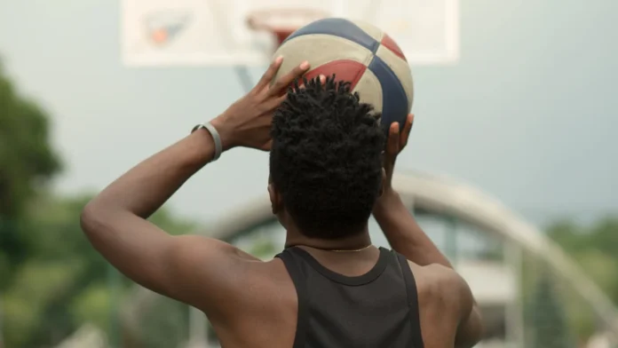 Back view of a basketball player aiming for the net