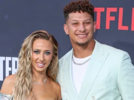 Brittany Mahomes and Patrick Mahomes posing at an event.