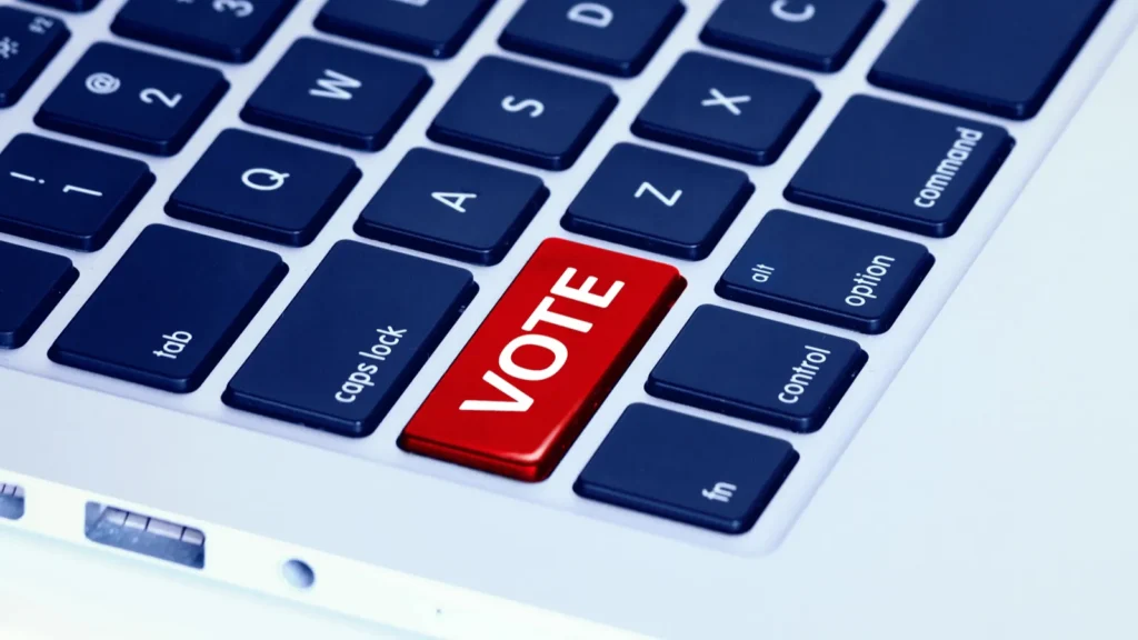 Closeup of a laptop keyboard with a red vote button