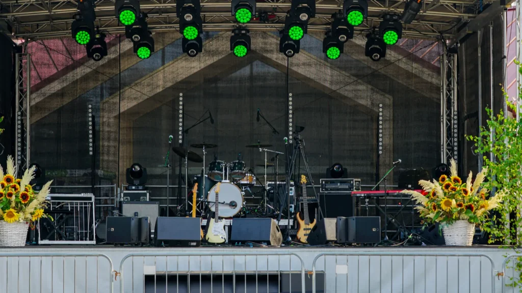 An empty outdoor stage prepared for a live concert with drums.