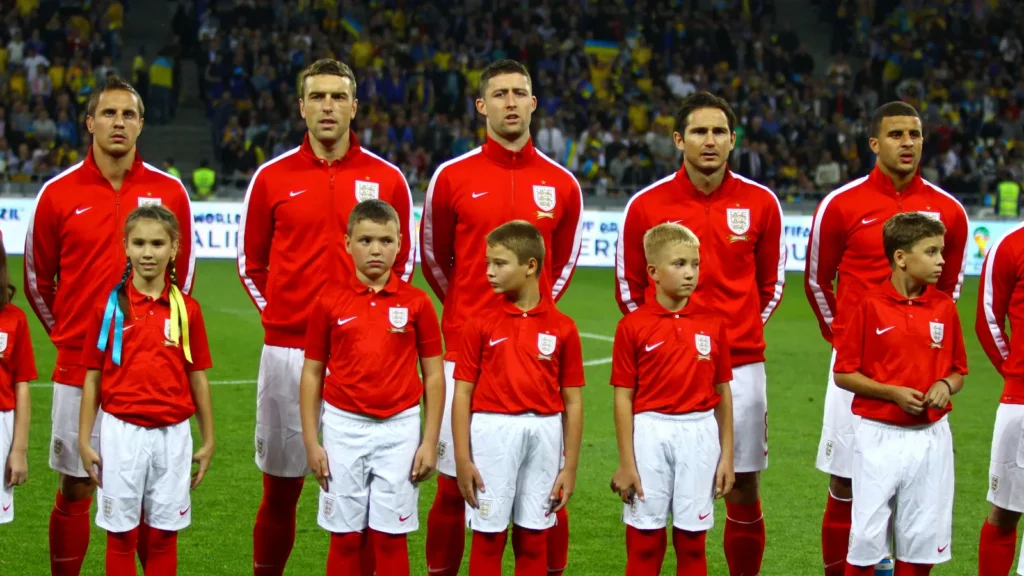 England soccer team standing on the field during national anthem.