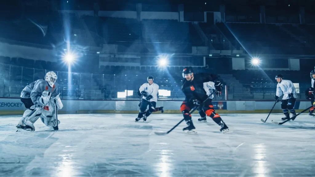 Ice hockey arena professional forward player breaks defense during the game.