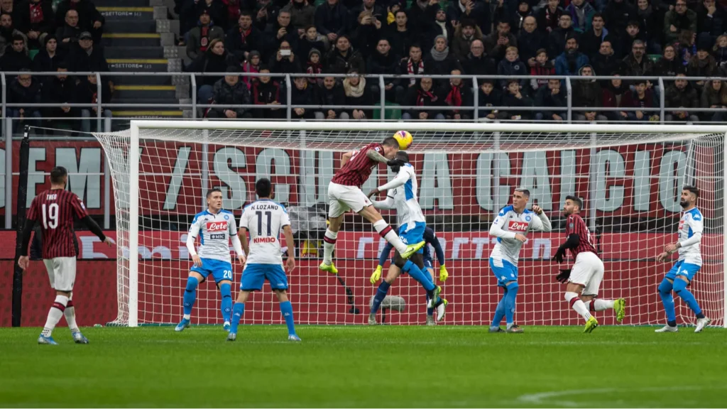 A Torino FC player attempting a header during a Serie A match against SSC Napoli.