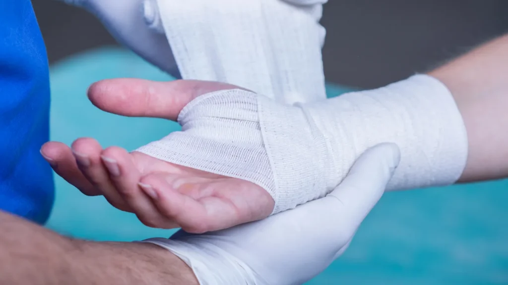 A doctor bandaging a hand