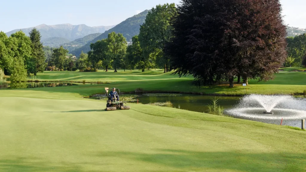 man on a machine for the maintenance of the golf