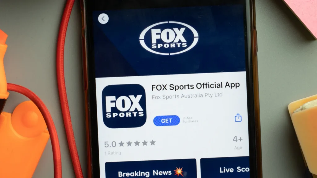 Smartphone displaying the FOX Sports Official App with the FOX Sports logo prominently visible on screen.