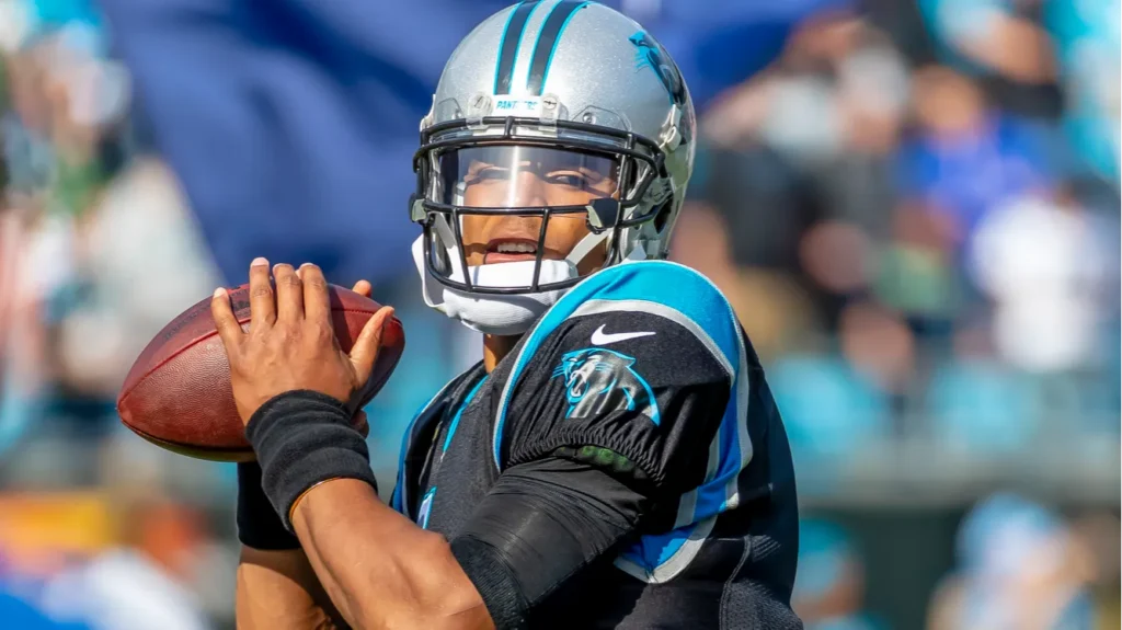 Cam Newton throws a pass