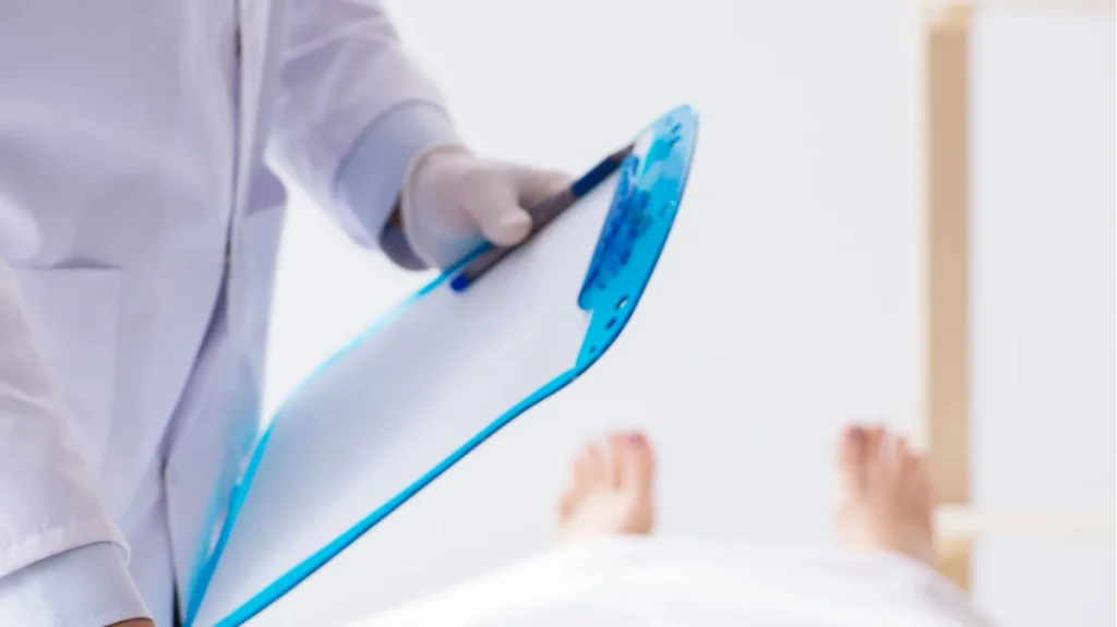 police coroner examining dead body corpse in morgue