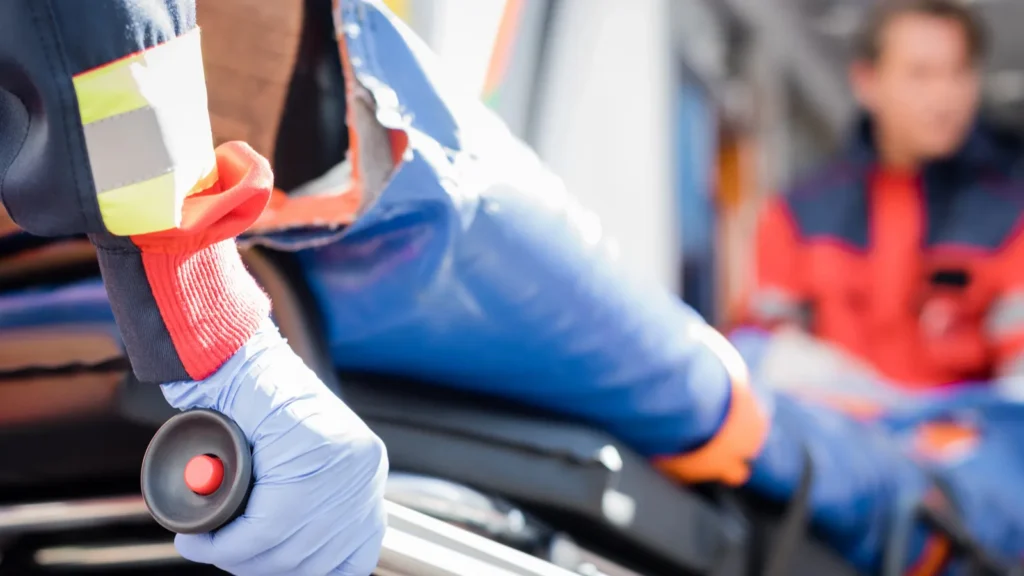 selective focus of paramedic in latex glove holding stretcher with