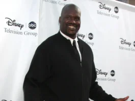 Former professional basketball player Shaquille O'Neal posing on a red carpet at a Disney ABC Television Group event.