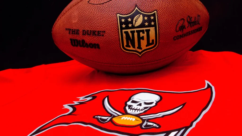 Tampa Bay Buccaneers logo underneath an official NFL football