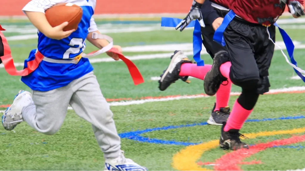 young flag football player being chased down during a youth