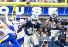 Dallas Cowboys shake up quarterback room after 6 games Dallas Cowboys player in navy jumps to catch a pass as Rams defenders converge, ball in midair near the goal line