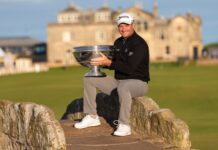 Ryan Fox celebrates winning the 2022 Alfred Dunhill Links Championship while holding the trophy on the iconic Swilcan Bridge at St Andrews.