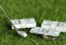 a bundle of bills and golf equipment on the green