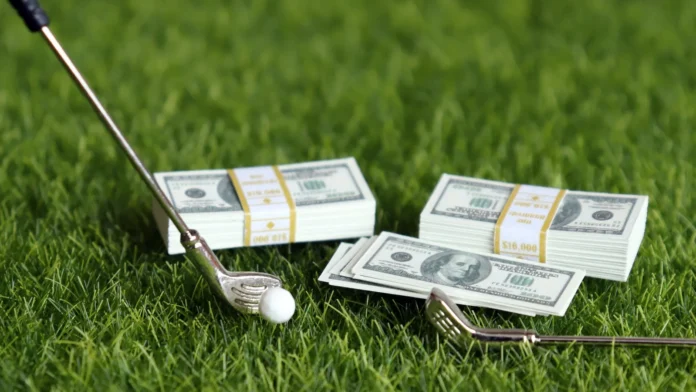 a bundle of bills and golf equipment on the green