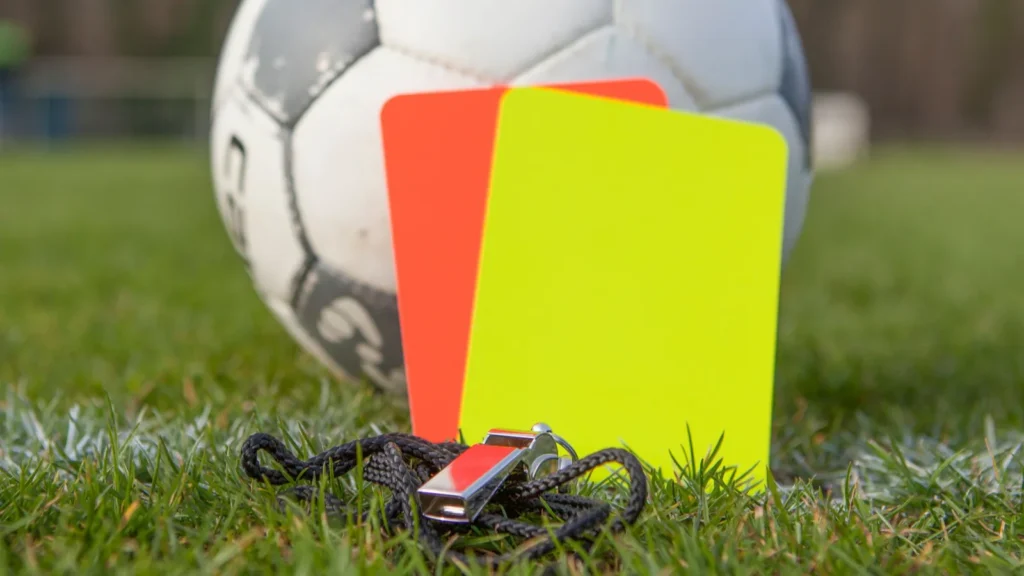 a closeup of soccer equipment on the grass  red