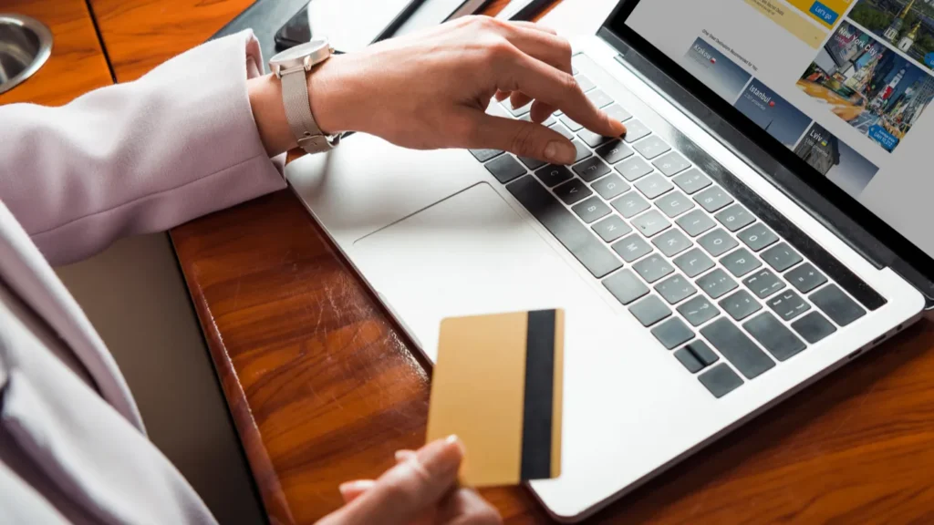 cropped view of businesswoman using laptop with booking website while
