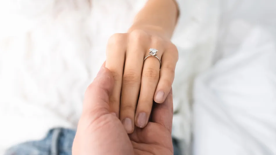 Cropped view of man holding hand of a woman