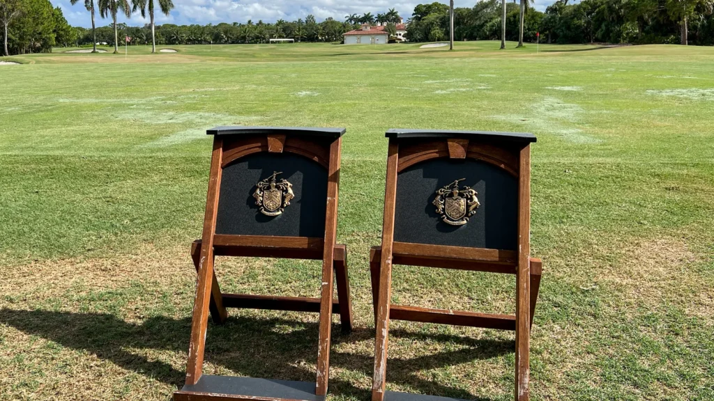 Custom-branded golf bag stands featuring the Trump family crest
