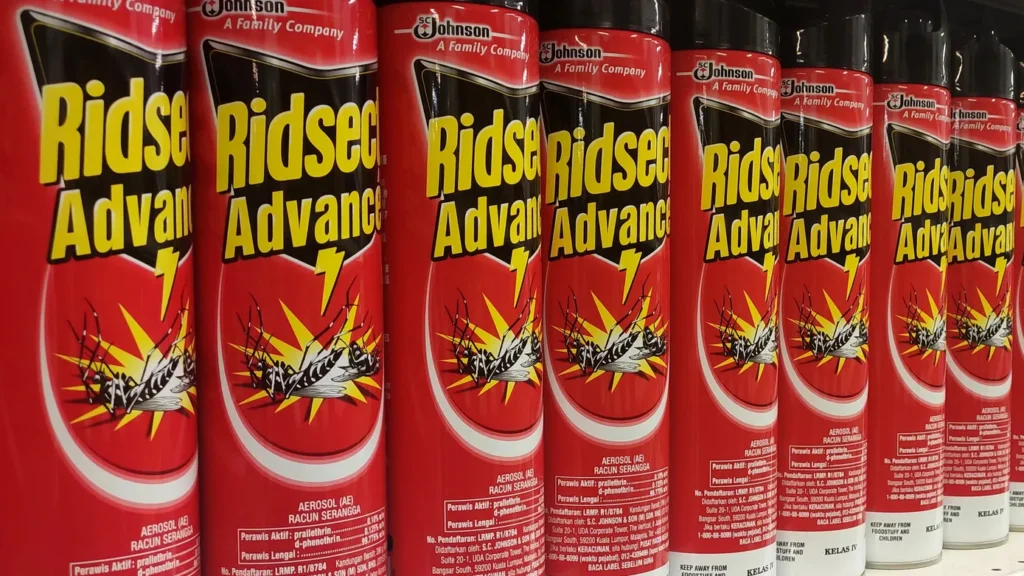 Stacks of insect spray inside a grocery store shelf