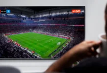 Man watching live soccer transmission on television.