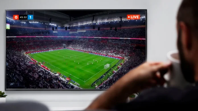 Man watching live soccer transmission on television.