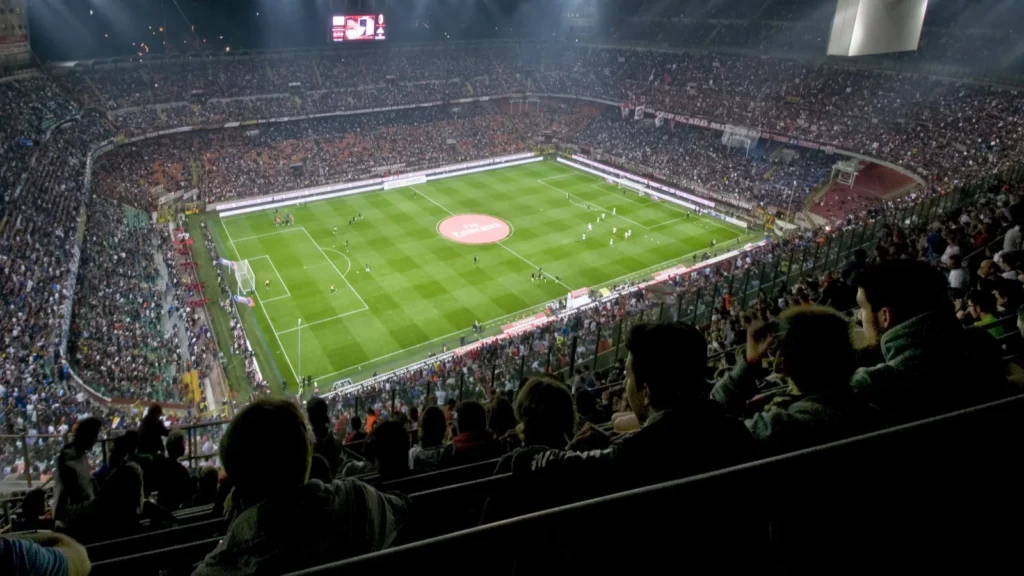 Football stadium with a crowd watching the game.