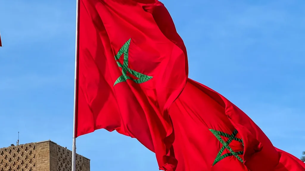 moroccan flags fluttering and the hassan tower in the background