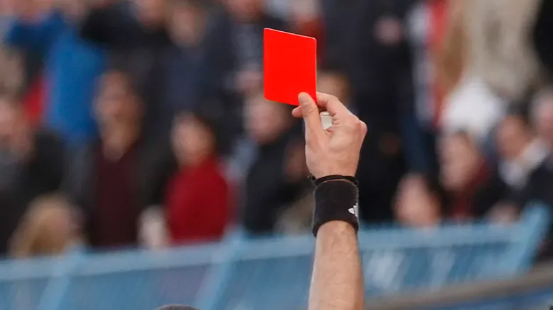 Referee holding up a red card