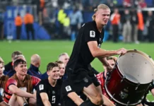 Erling Haaland celebrating with a drum alongside his Norwegian teammates