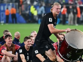 Erling Haaland celebrating with a drum alongside his Norwegian teammates