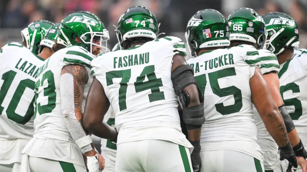 new york jets linemen in a pre snap huddle during
