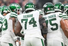 new york jets linemen in a pre snap huddle during