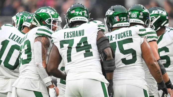 new york jets linemen in a pre snap huddle during