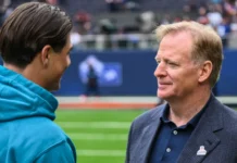 NFL commissioner Roger Goodell chats with Louis Reeszammit on the field