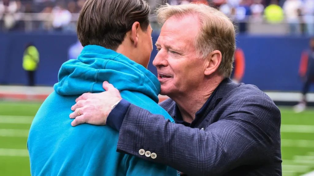 NFL Commissioner Roger Goodell embraces Louis Reeszammit of the Jacksonville