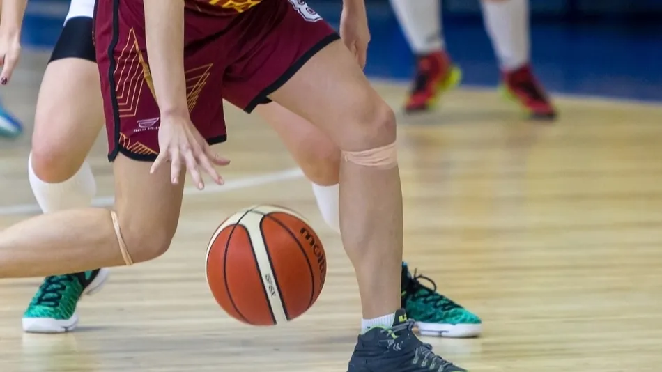 close-up of a basketball player dribbling the ball