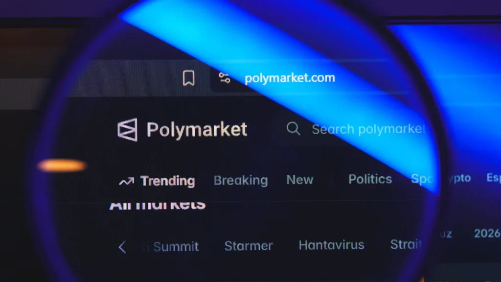 Polymarket website interface viewed through a magnifying glass