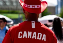rear view of canada fan wearing red cowboy hat at