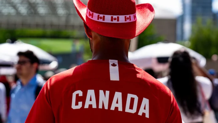 rear view of canada fan wearing red cowboy hat at rear view of canada fan wearing red cowboy hat at