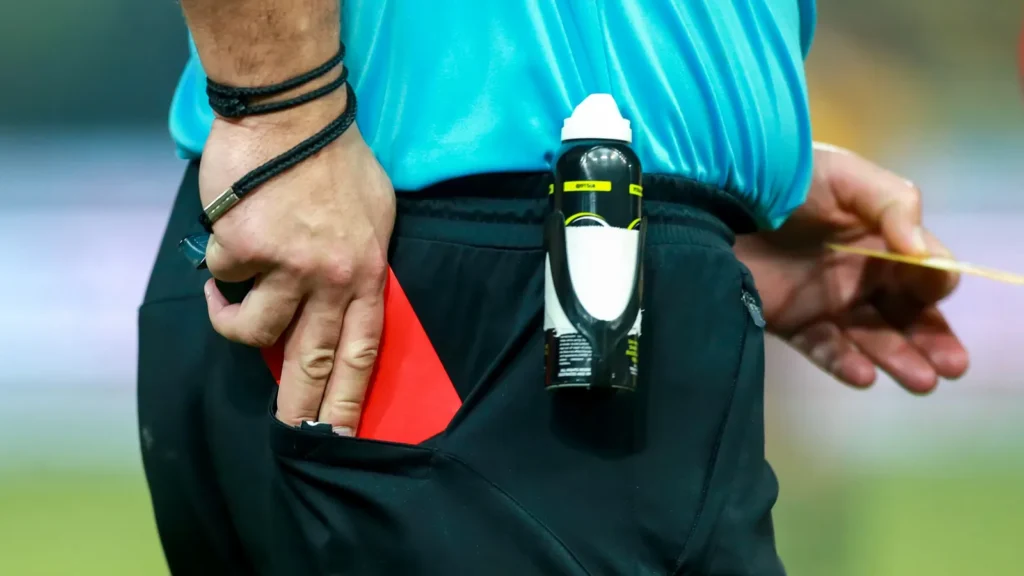 Referee drawing the red card