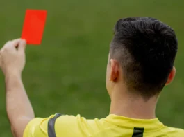 referee showing a red card to a displeased football or