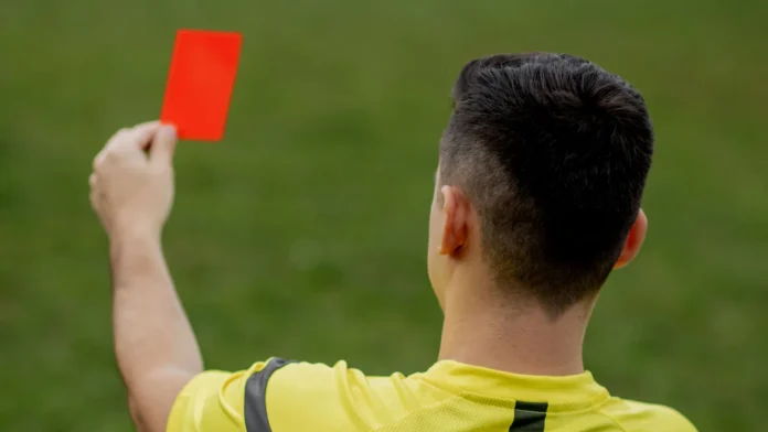 referee showing a red card to a displeased football or referee showing a red card to a displeased football or