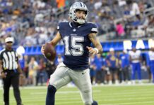 Panthers quarterback Will Grier ends NFL career at 31 Dallas Cowboys football player wearing #15 runs with the ball during a game on the field while fans watch in the stands.